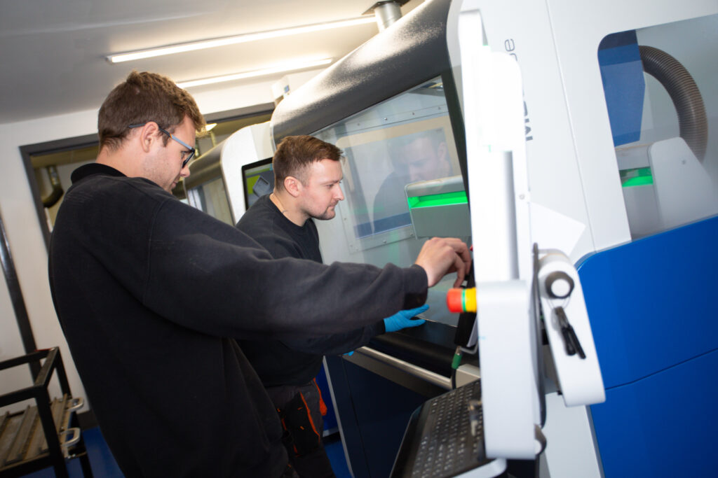 2 men operating a CNC machine