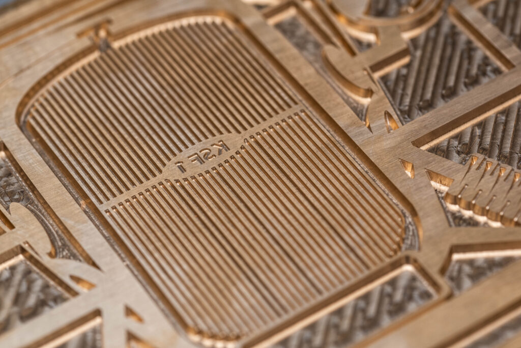 Close up of a brass plate die showing the detail