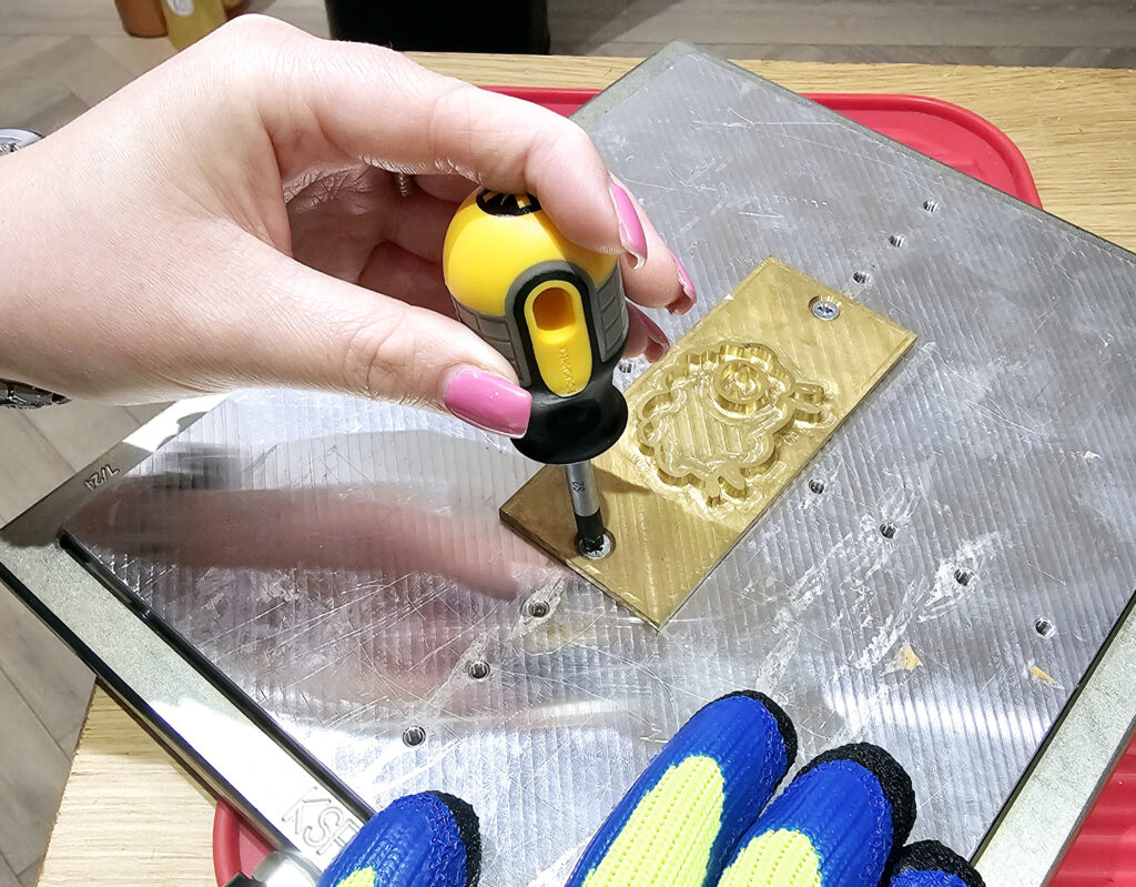 A die plate being screwed into place