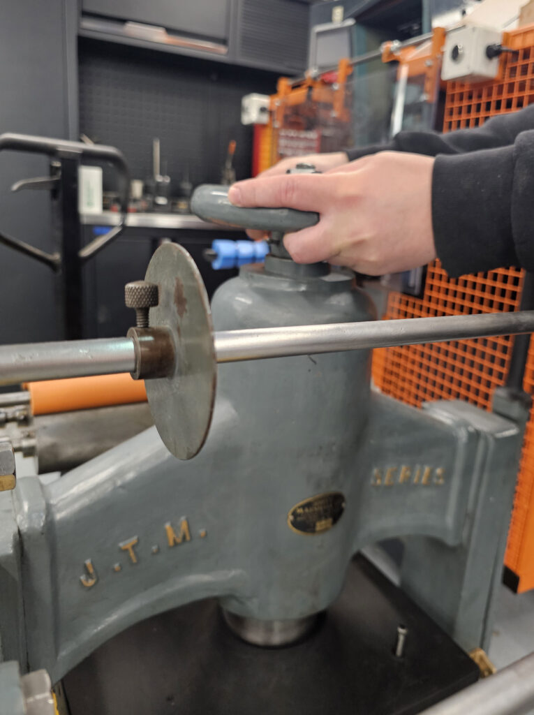 Man maintaining an original John T Marshall press