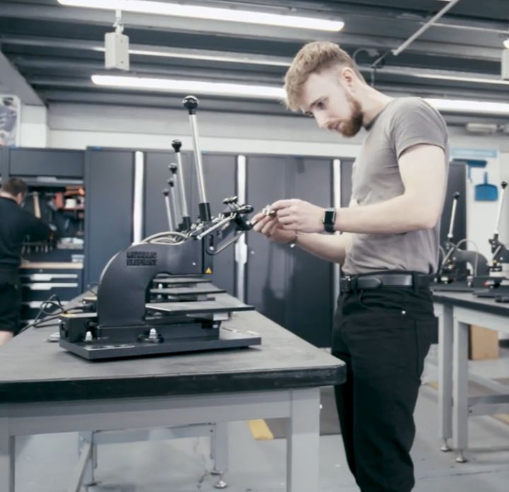 Man putting together a hot foil press machine